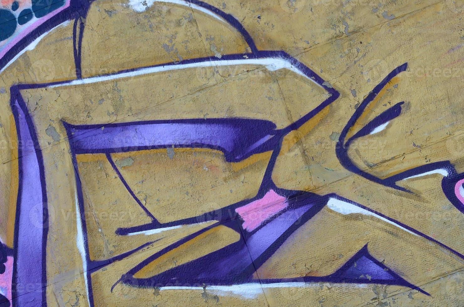 Fragment of graffiti drawings. The old wall decorated with paint stains in the style of street art culture. Colored background texture in purple tones photo