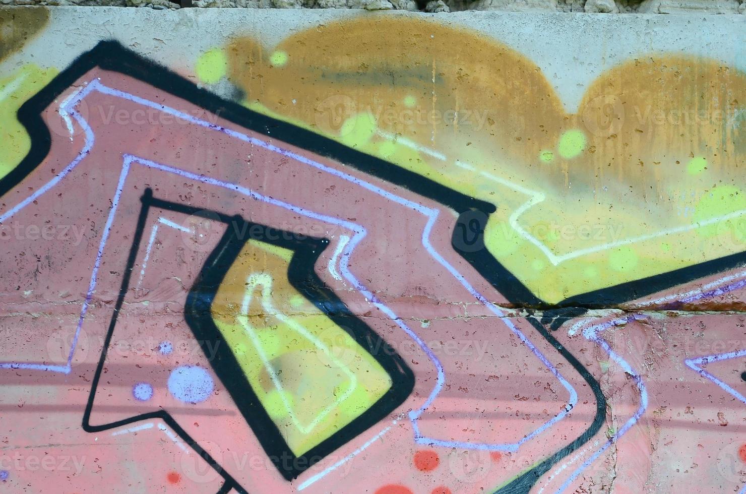 Fragment of graffiti drawings. The old wall decorated with paint stains in the style of street art culture. Colored background texture in warm tones photo