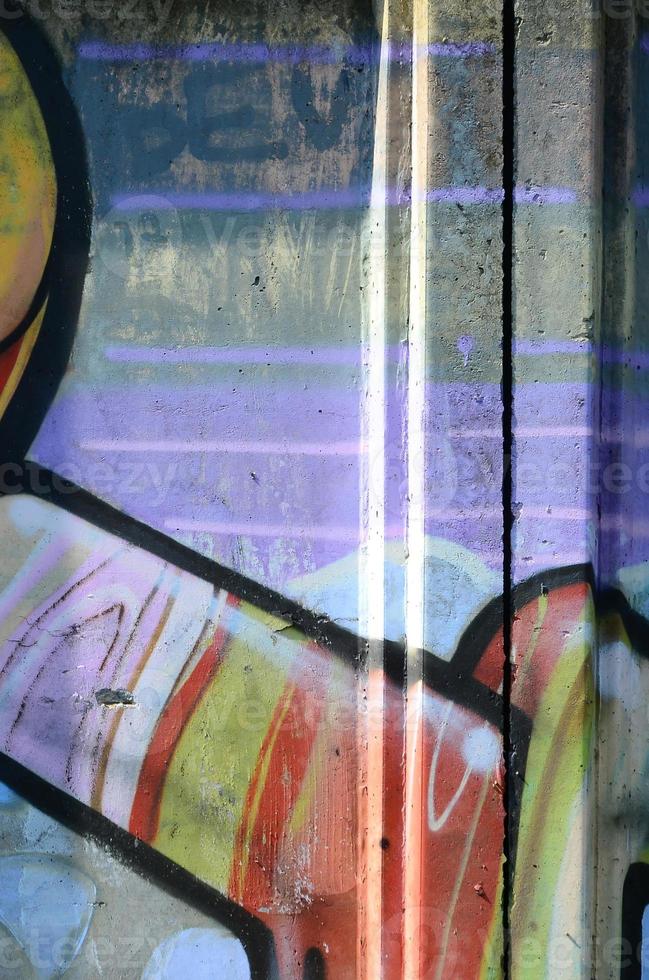 Fragment of graffiti drawings. The old wall decorated with paint stains in the style of street art culture. Multicolored background texture photo