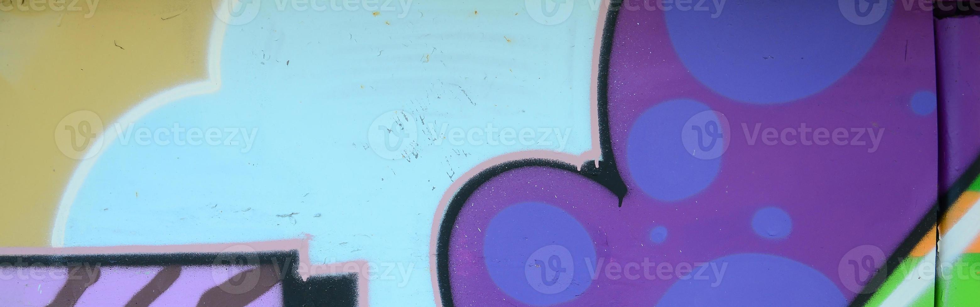 Fragment of graffiti drawings. The old wall decorated with paint stains in the style of street art culture. Multicolored background texture photo