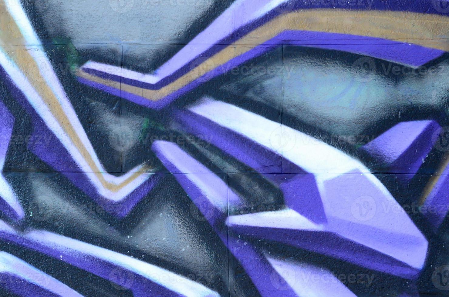 Fragment of graffiti drawings. The old wall decorated with paint stains in the style of street art culture. Colored background texture in purple tones photo