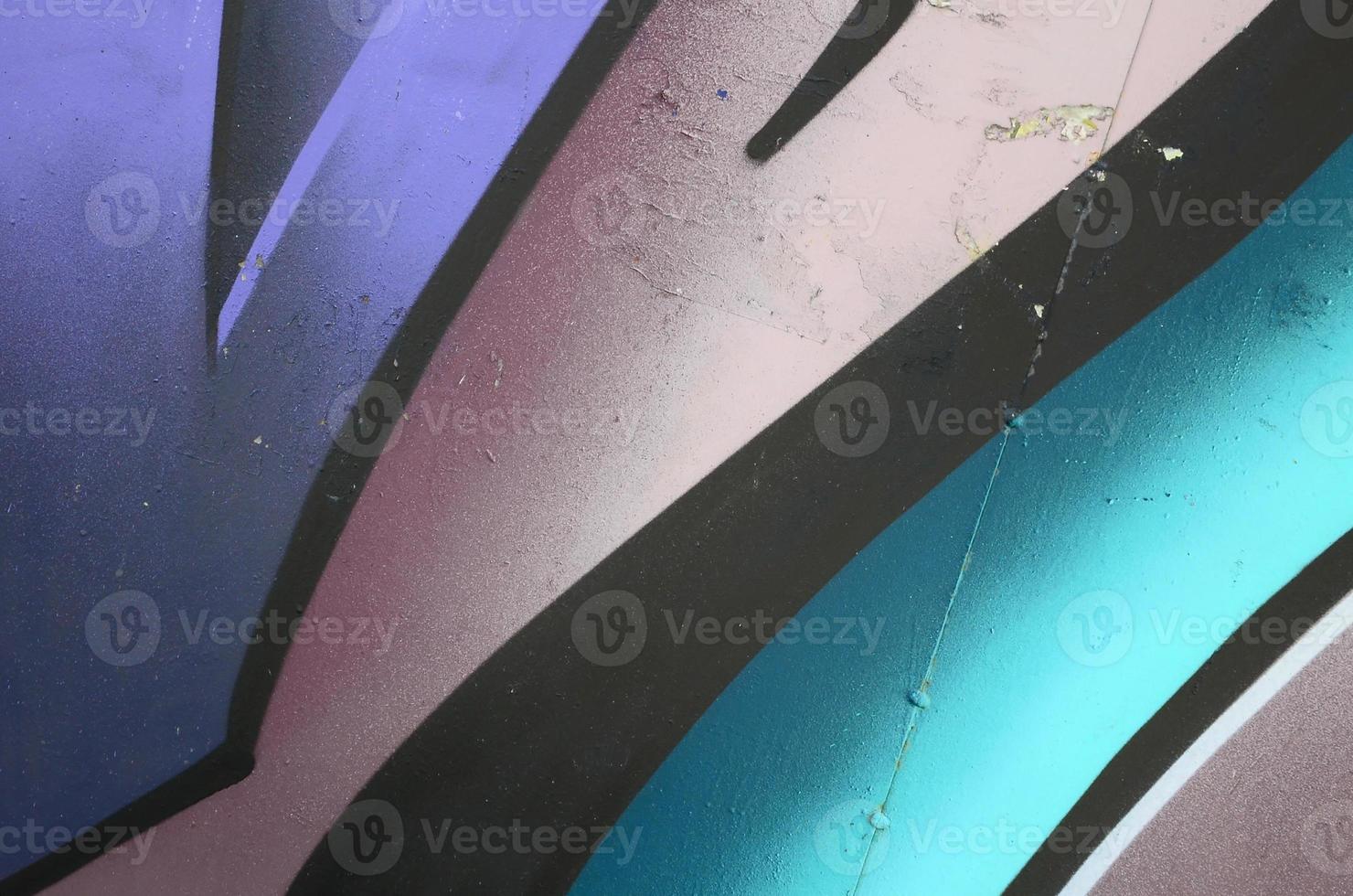 Fragment of graffiti drawings. The old wall decorated with paint stains in the style of street art culture. Colored background texture in cold tones photo