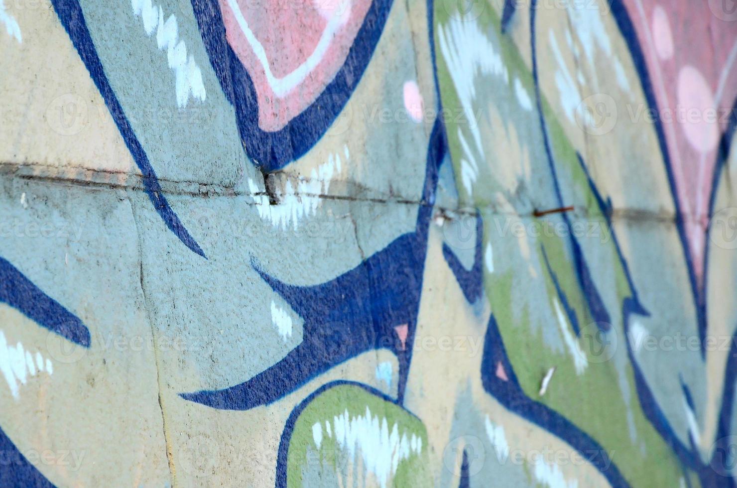 Fragment of graffiti drawings. The old wall decorated with paint stains in the style of street art culture. Colored background texture in green tones photo