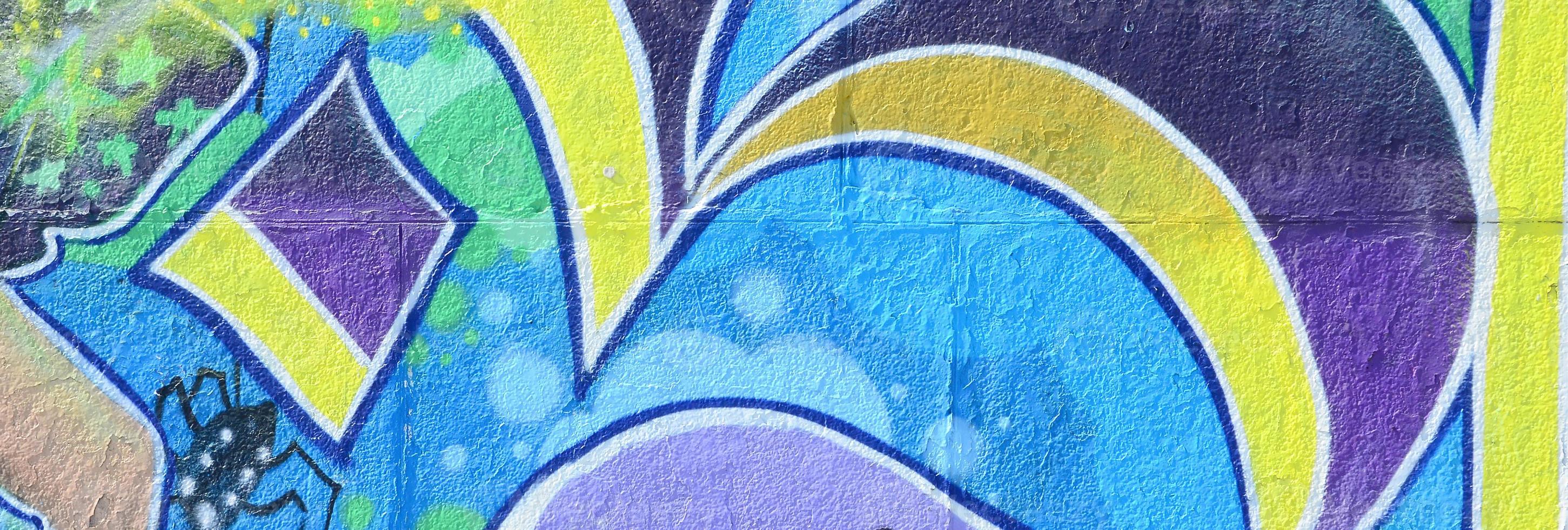 Fragment of graffiti drawings. The old wall decorated with paint stains in the style of street art culture. Colored background texture in cold tones photo