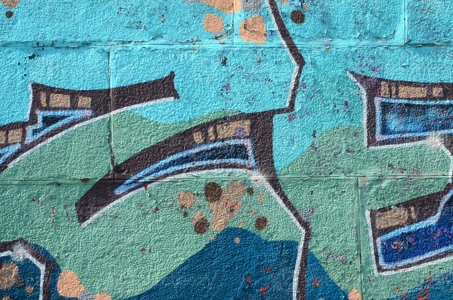 Fragment of graffiti drawings. The old wall decorated with paint stains in the style of street art culture. Colored background texture in cold tones photo