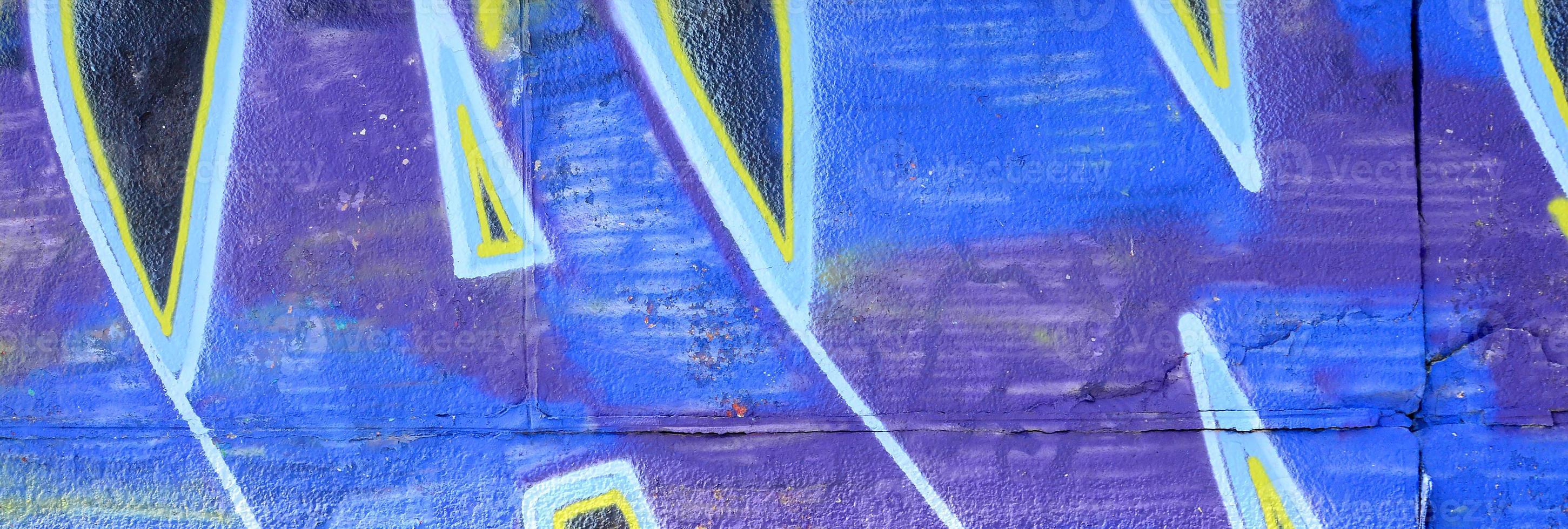 Fragment of graffiti drawings. The old wall decorated with paint stains in the style of street art culture. Colored background texture in cold tones photo
