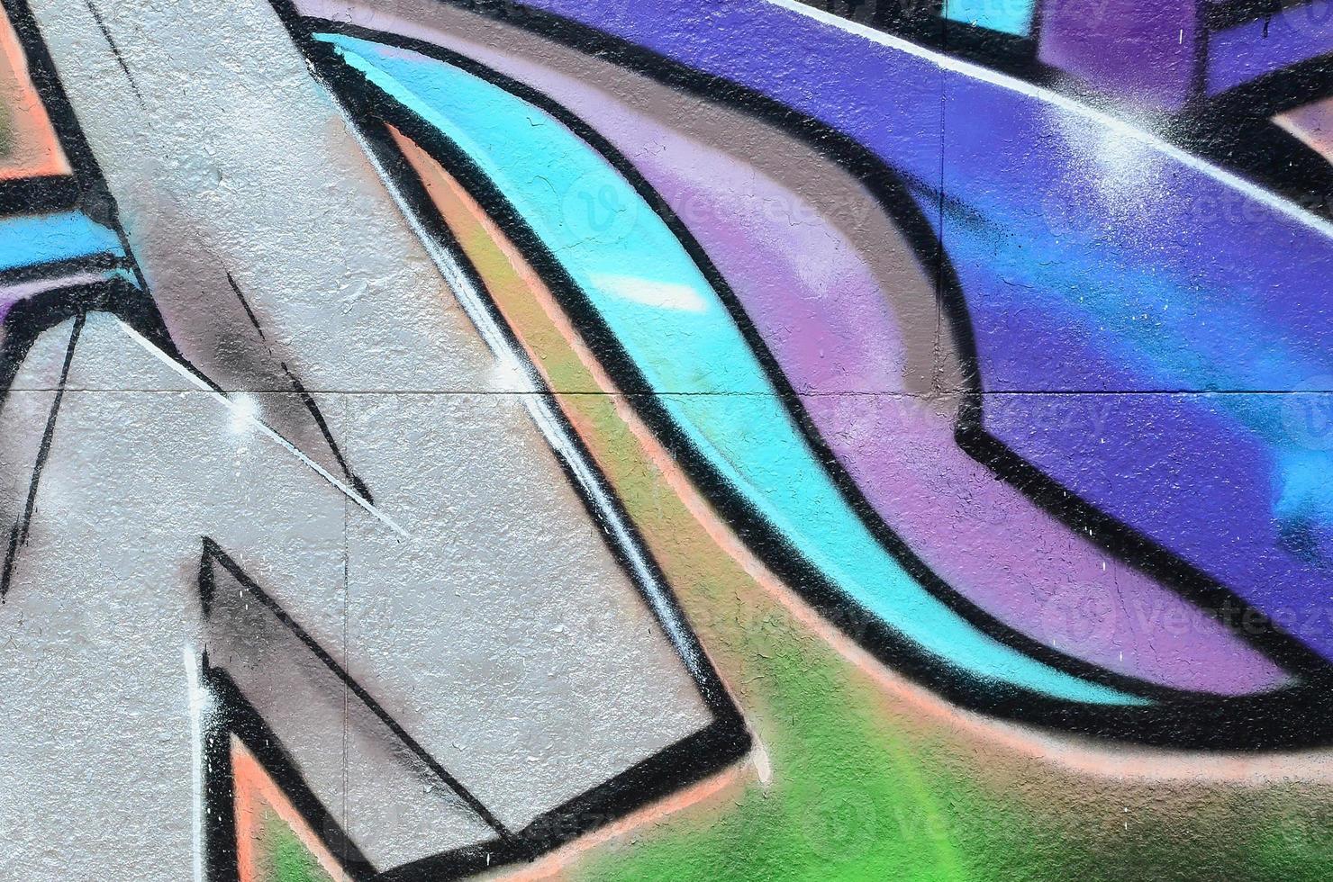Fragment of graffiti drawings. The old wall decorated with paint stains in the style of street art culture. Colored background texture in purple tones photo