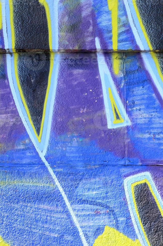 Fragment of graffiti drawings. The old wall decorated with paint stains in the style of street art culture. Colored background texture in cold tones photo