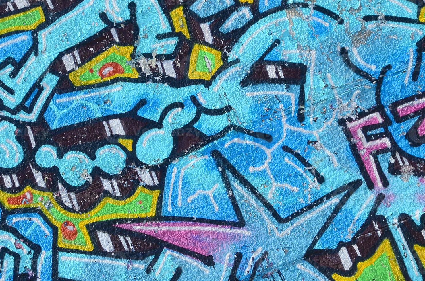 Fragment of graffiti drawings. The old wall decorated with paint stains in the style of street art culture. Colored background texture in cold tones photo