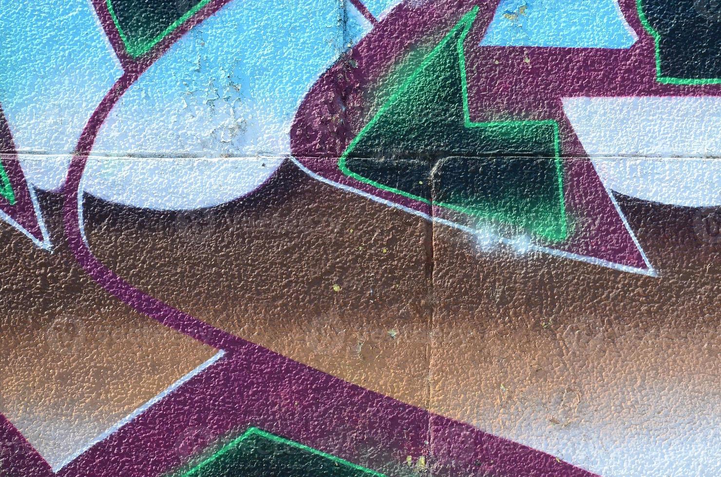 Fragment of graffiti drawings. The old wall decorated with paint stains in the style of street art culture. Colored background texture in cold tones photo