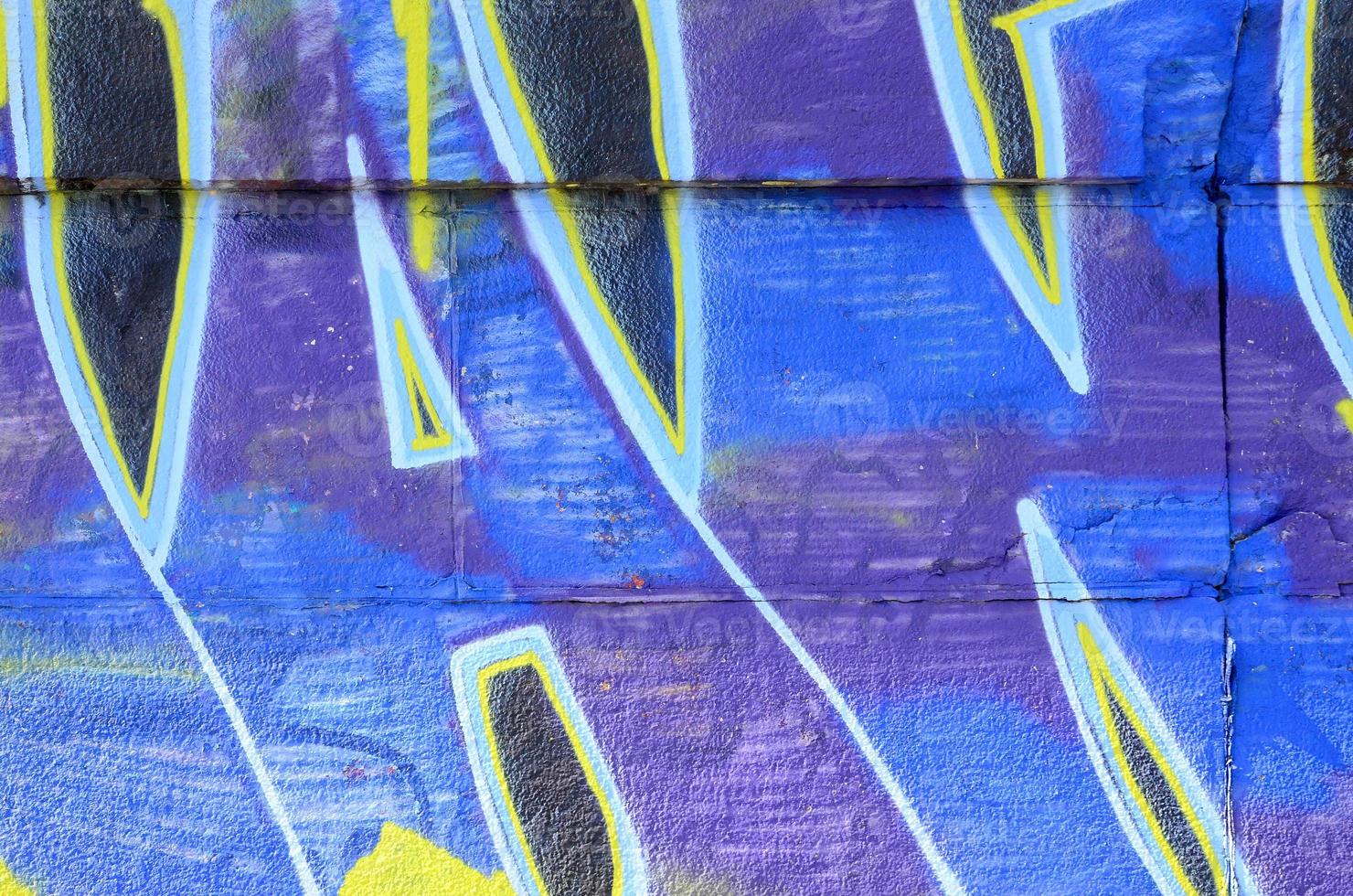 Fragment of graffiti drawings. The old wall decorated with paint stains in the style of street art culture. Colored background texture in cold tones photo