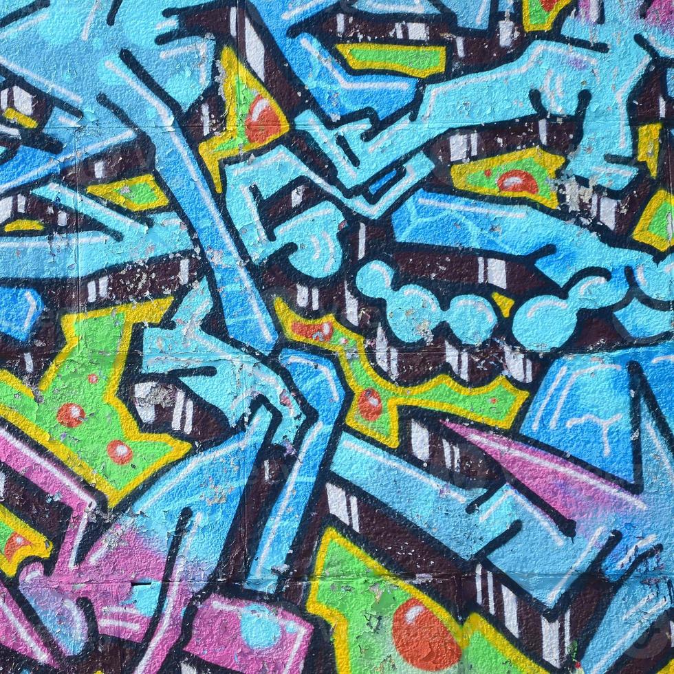 Fragment of graffiti drawings. The old wall decorated with paint stains in the style of street art culture. Colored background texture in cold tones photo
