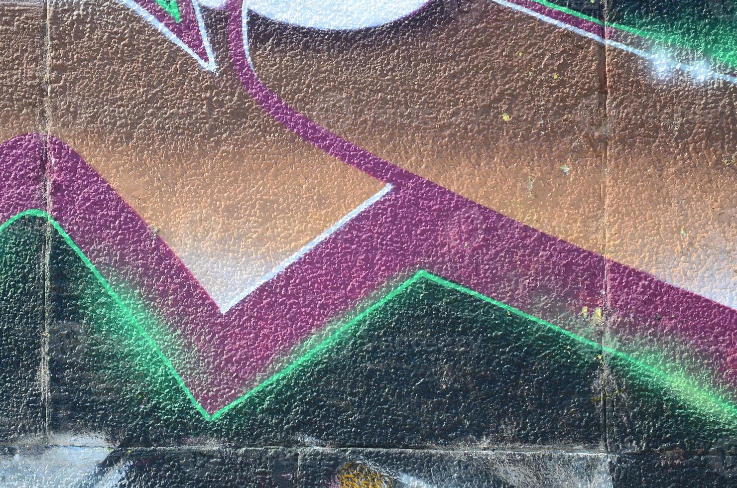 Fragment of graffiti drawings. The old wall decorated with paint stains in the style of street art culture. Colored background texture in cold tones photo