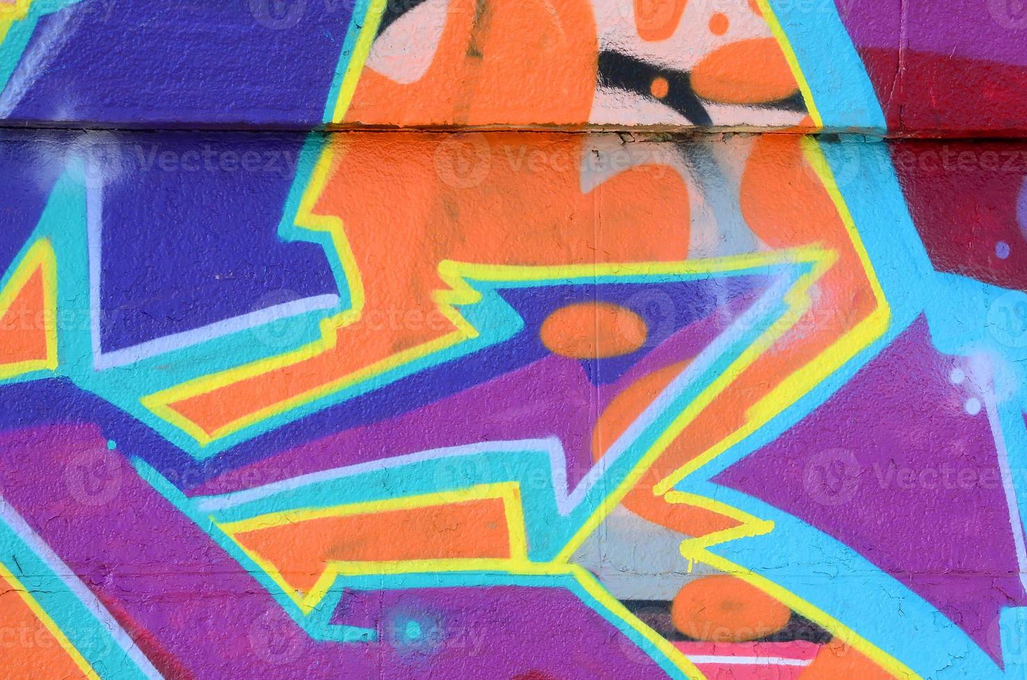 Fragment of graffiti drawings. The old wall decorated with paint stains in the style of street art culture. Colored background texture in purple tones photo