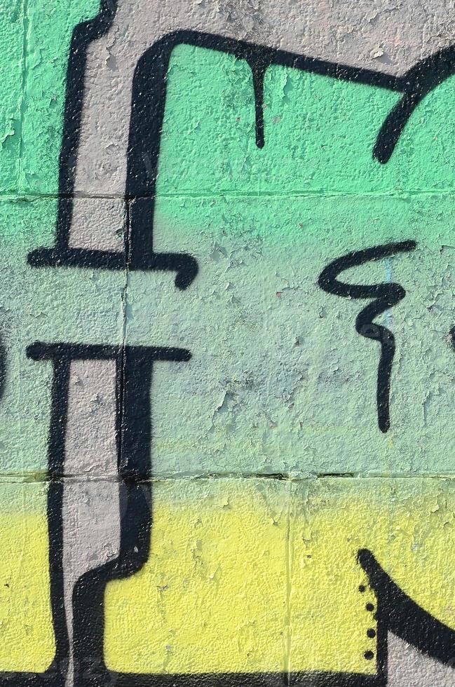 Fragment of graffiti drawings. The old wall decorated with paint stains in the style of street art culture. Colored background texture in green tones photo