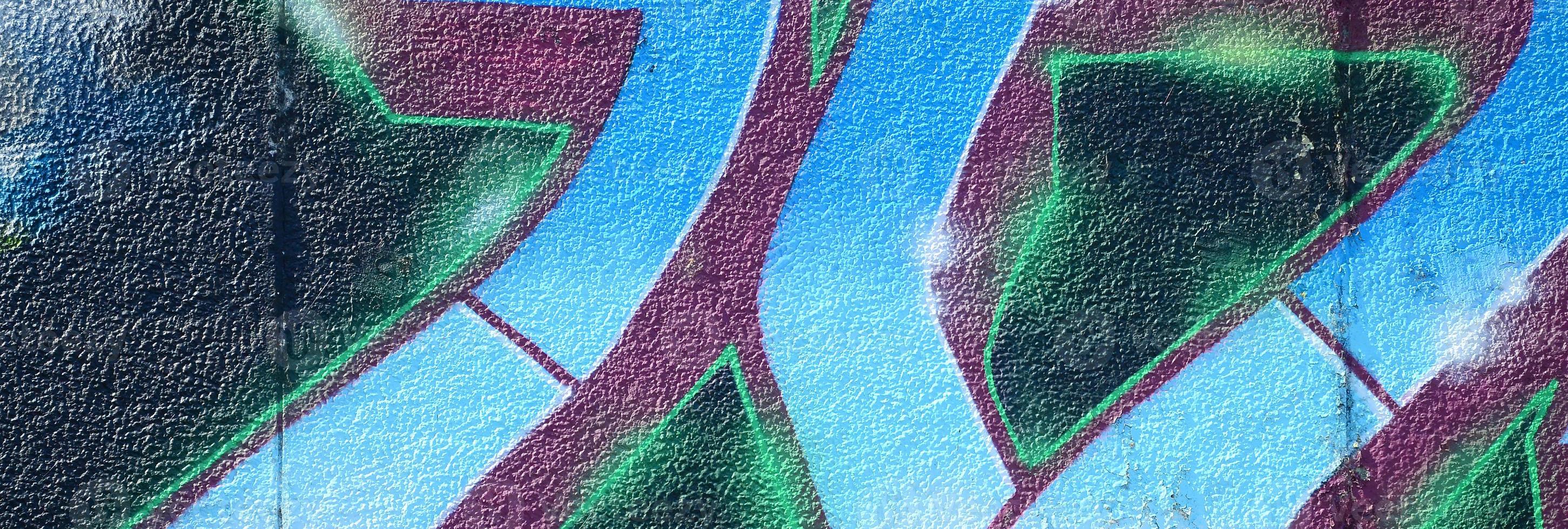 Fragment of graffiti drawings. The old wall decorated with paint stains in the style of street art culture. Colored background texture in cold tones photo