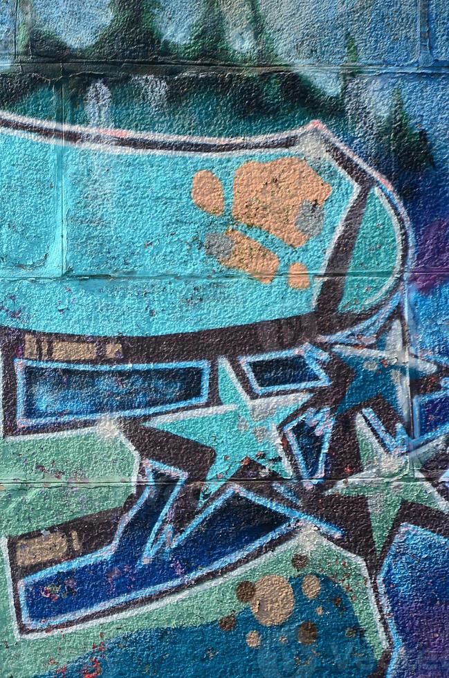 Fragment of graffiti drawings. The old wall decorated with paint stains in the style of street art culture. Colored background texture in cold tones photo