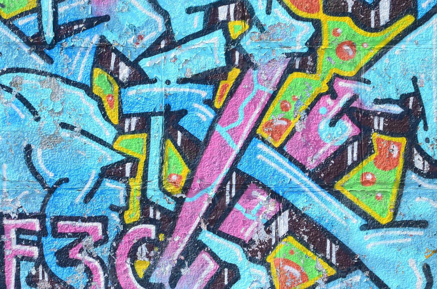 Fragment of graffiti drawings. The old wall decorated with paint stains in the style of street art culture. Colored background texture in cold tones photo