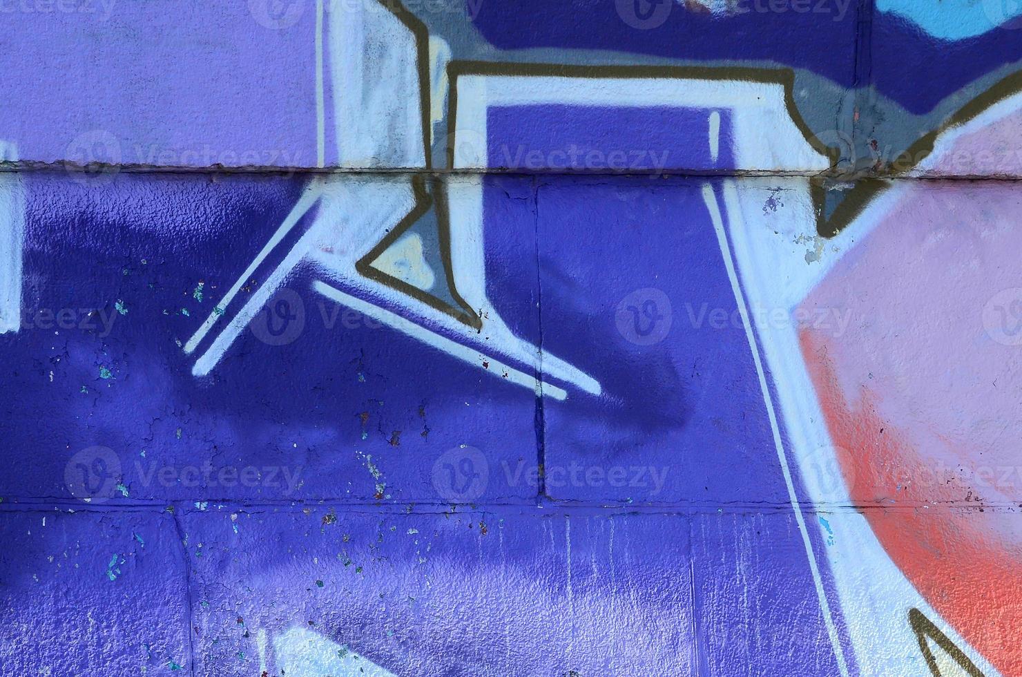 Fragment of graffiti drawings. The old wall decorated with paint stains in the style of street art culture. Colored background texture in cold tones photo