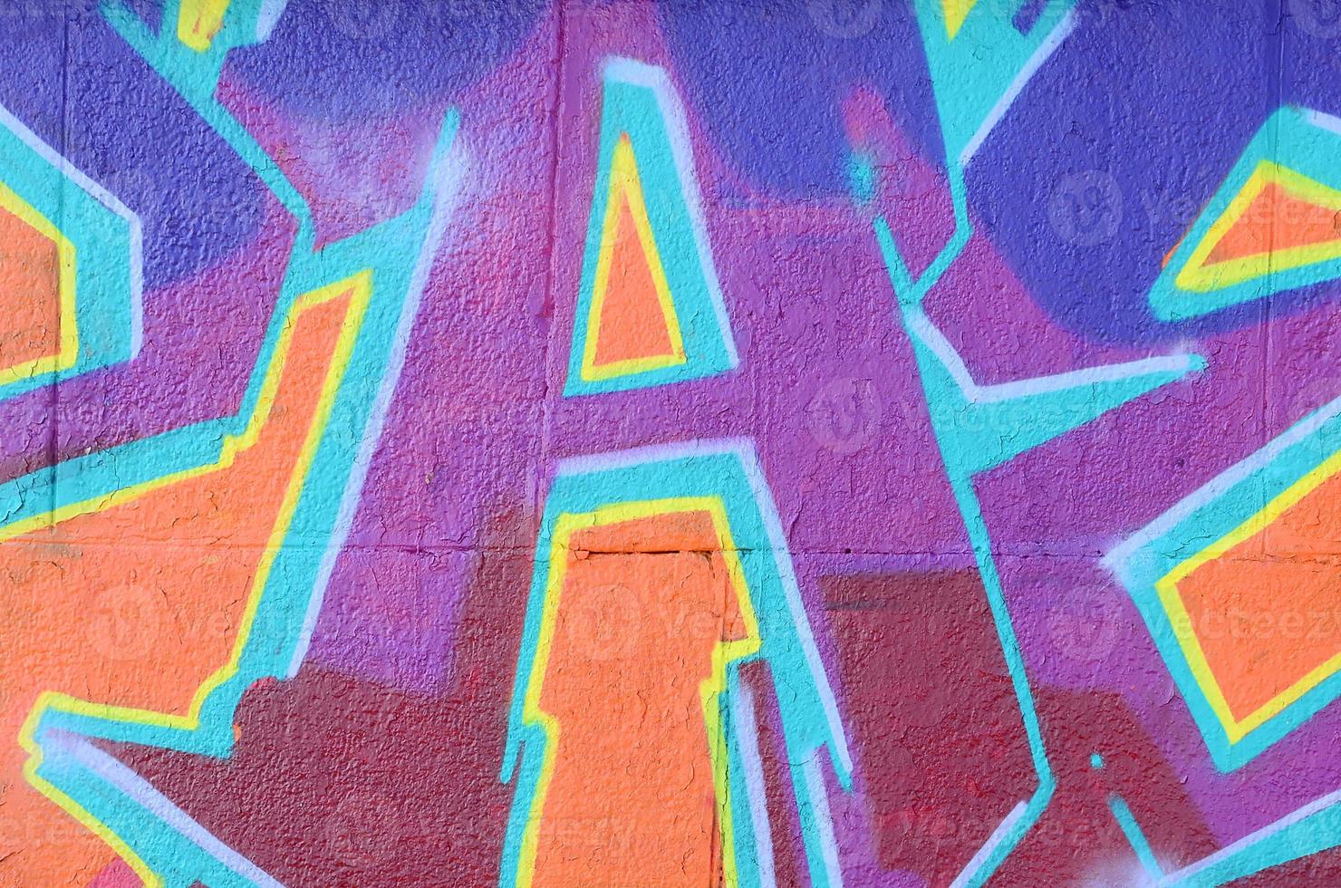 Fragment of graffiti drawings. The old wall decorated with paint stains in the style of street art culture. Colored background texture in purple tones photo