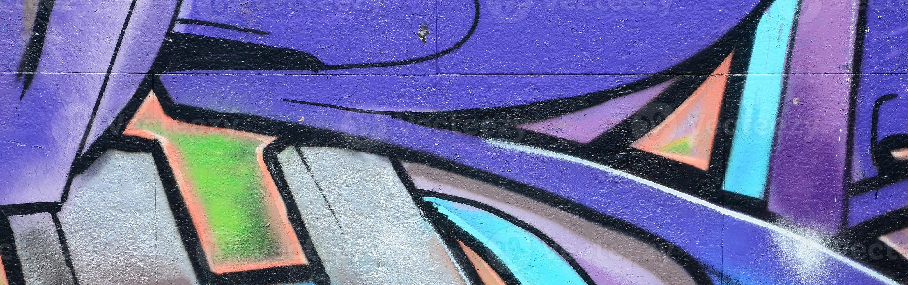 Fragment of graffiti drawings. The old wall decorated with paint stains in the style of street art culture. Colored background texture in purple tones photo