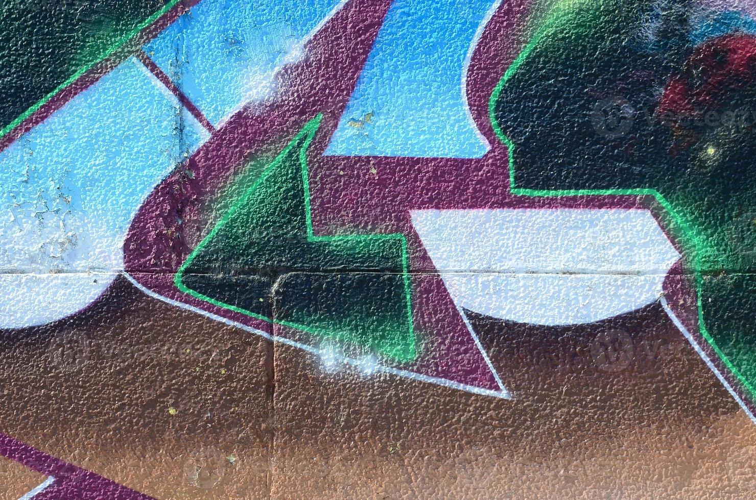 Fragment of graffiti drawings. The old wall decorated with paint stains in the style of street art culture. Colored background texture in cold tones photo