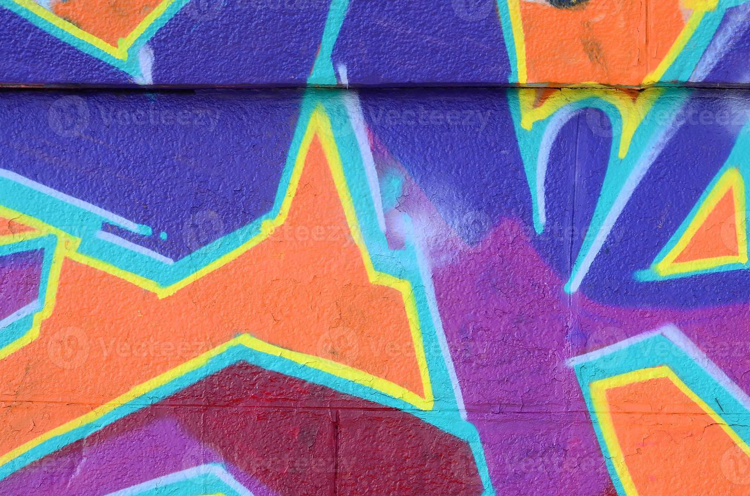 Fragment of graffiti drawings. The old wall decorated with paint stains in the style of street art culture. Colored background texture in purple tones photo