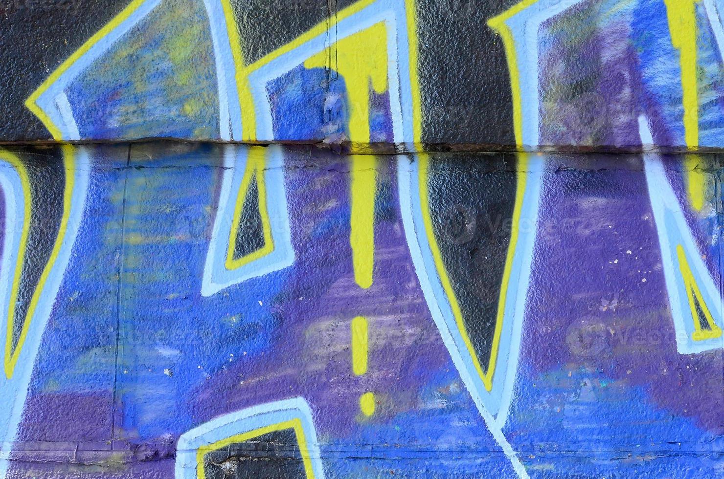 Fragment of graffiti drawings. The old wall decorated with paint stains in the style of street art culture. Colored background texture in cold tones photo