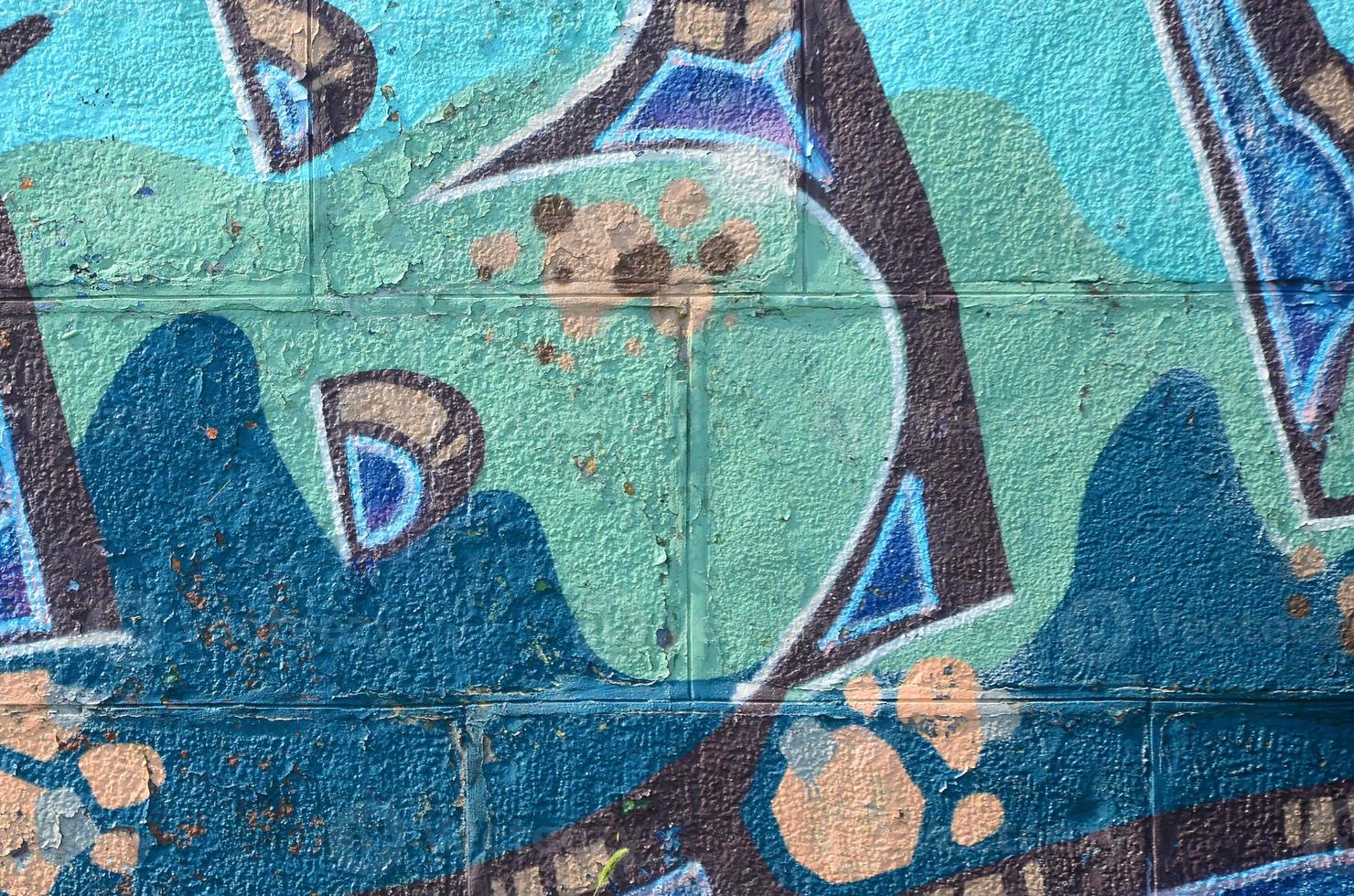 Fragment of graffiti drawings. The old wall decorated with paint stains in the style of street art culture. Colored background texture in cold tones photo