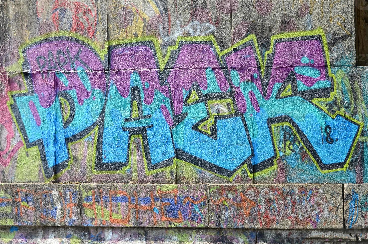 Fragment of graffiti drawings. The old wall decorated with paint stains in the style of street art culture. Colored background texture in cold tones photo