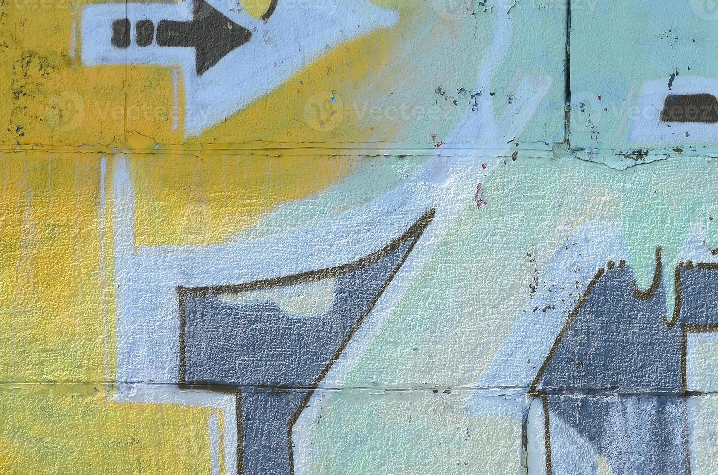 Fragment of graffiti drawings. The old wall decorated with paint stains in the style of street art culture. Multicolored background texture photo