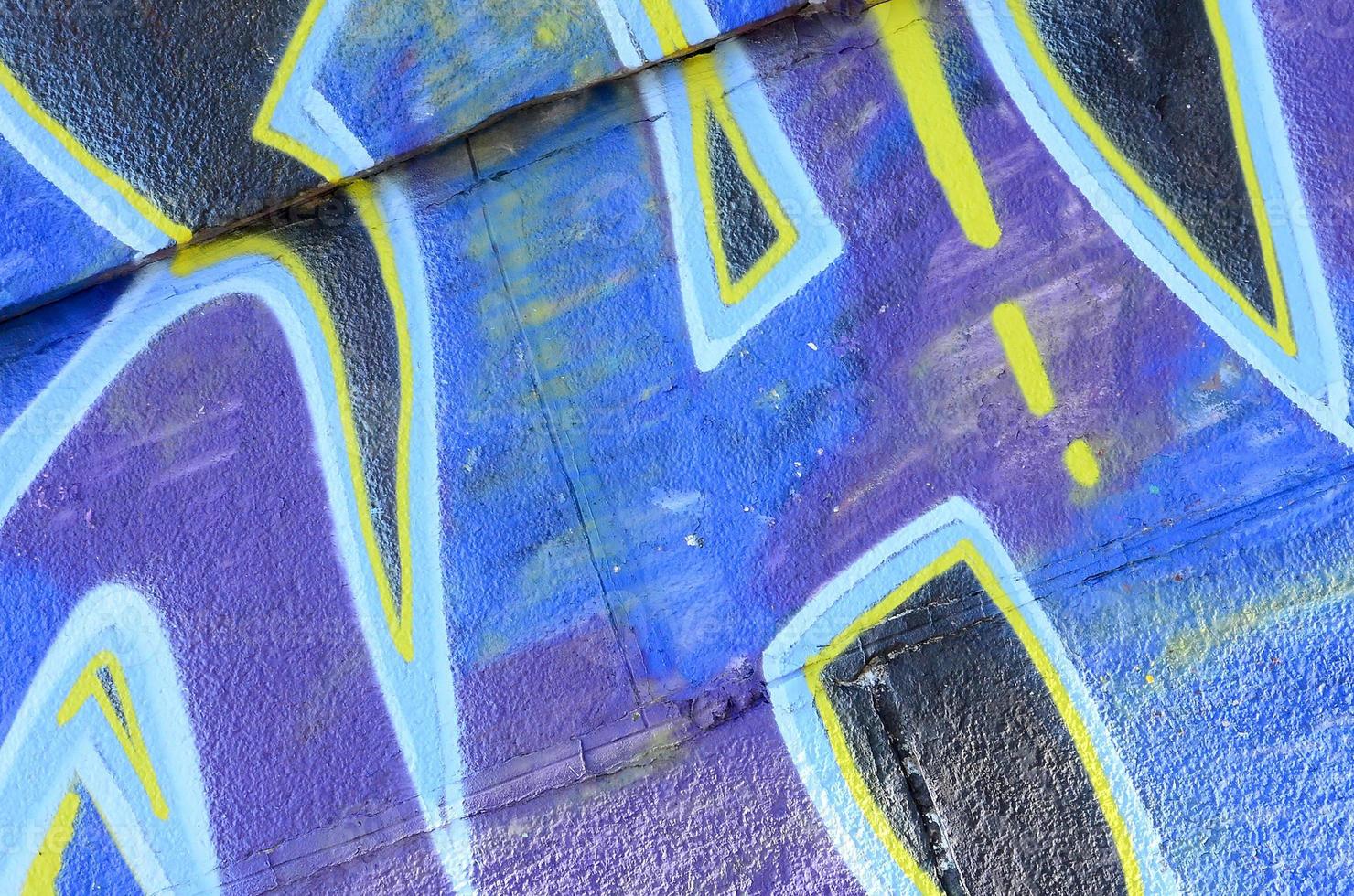 Fragment of graffiti drawings. The old wall decorated with paint stains in the style of street art culture. Colored background texture in cold tones photo