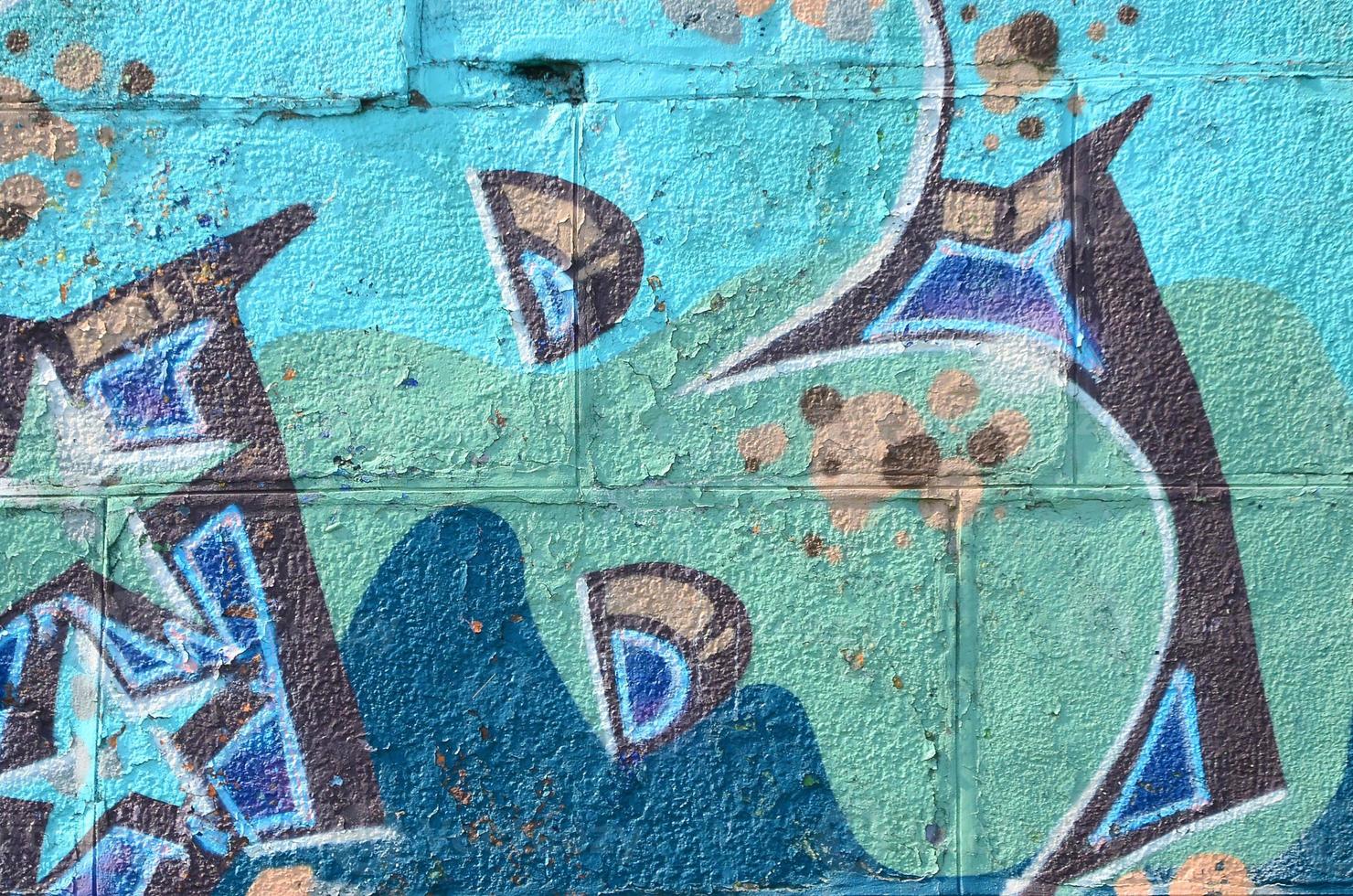 Fragment of graffiti drawings. The old wall decorated with paint stains in the style of street art culture. Colored background texture in cold tones photo