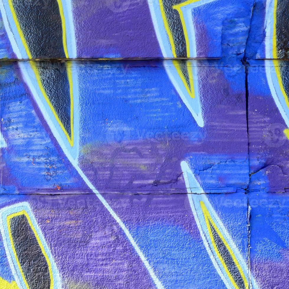 Fragment of graffiti drawings. The old wall decorated with paint stains in the style of street art culture. Colored background texture in cold tones photo