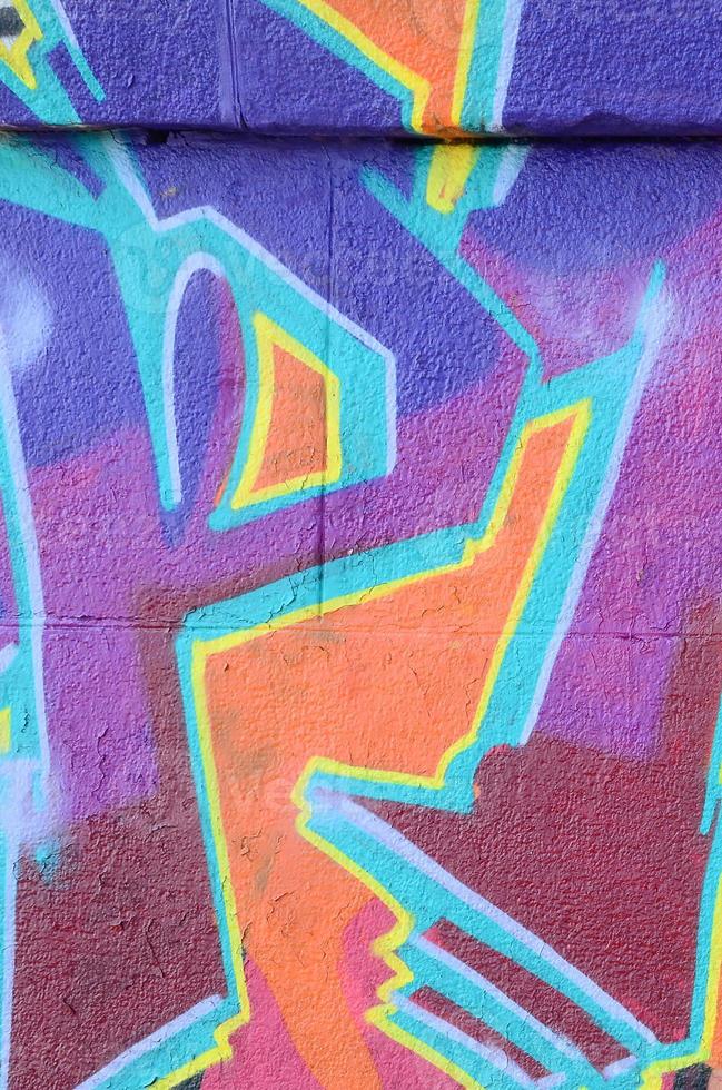Fragment of graffiti drawings. The old wall decorated with paint stains in the style of street art culture. Colored background texture in purple tones photo
