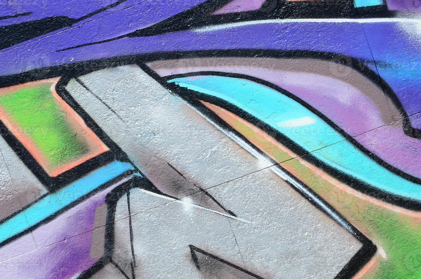 Fragment of graffiti drawings. The old wall decorated with paint stains in the style of street art culture. Colored background texture in purple tones photo