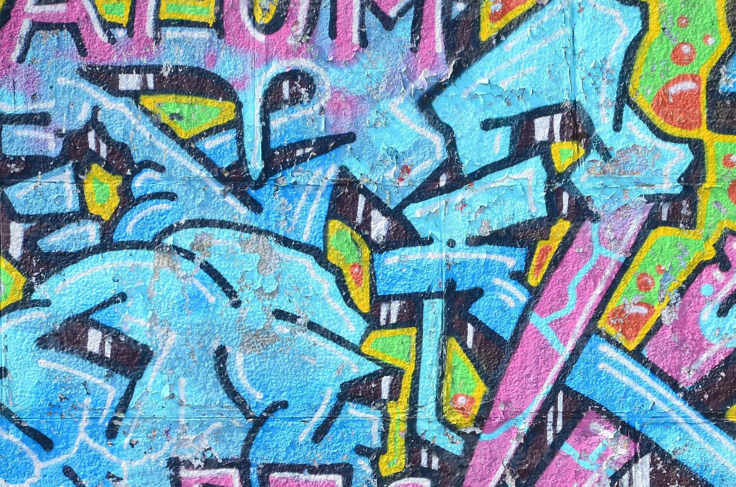 Fragment of graffiti drawings. The old wall decorated with paint stains in the style of street art culture. Colored background texture in cold tones photo