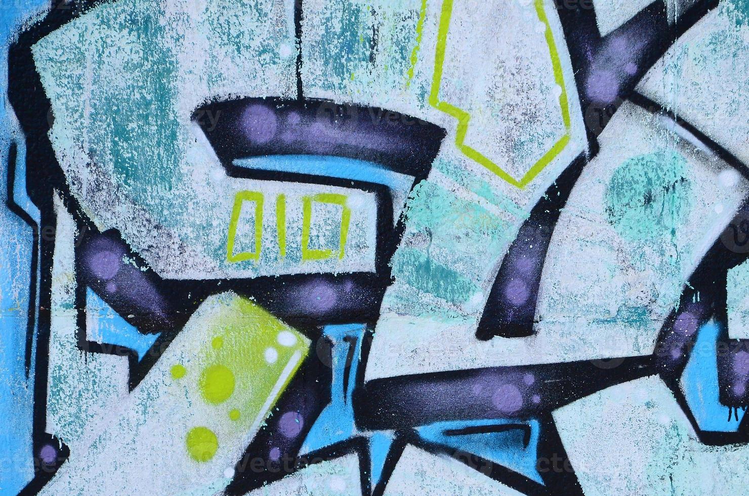 Fragment of graffiti drawings. The old wall decorated with paint stains in the style of street art culture. Colored background texture in cold tones photo