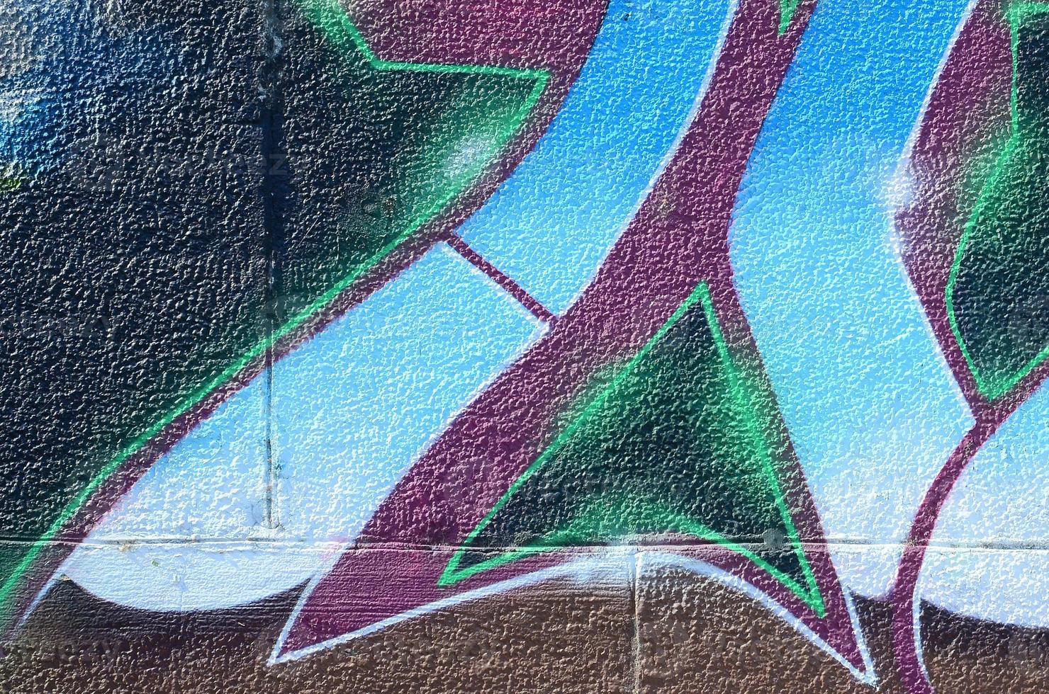 Fragment of graffiti drawings. The old wall decorated with paint stains in the style of street art culture. Colored background texture in cold tones photo