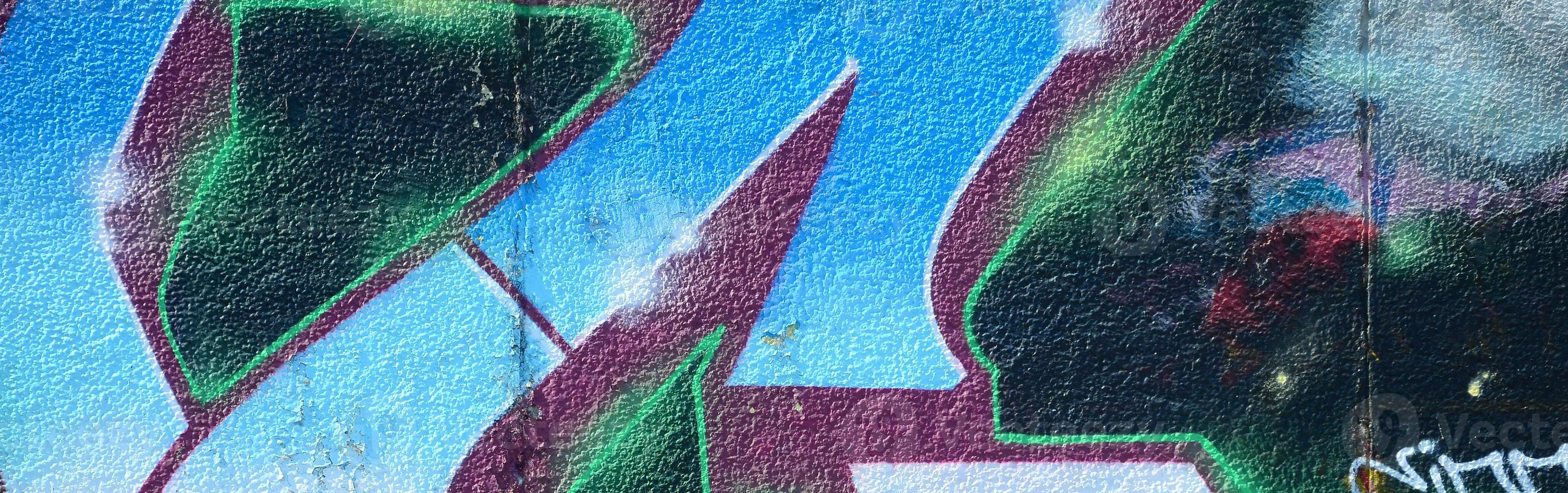 Fragment of graffiti drawings. The old wall decorated with paint stains in the style of street art culture. Colored background texture in cold tones photo