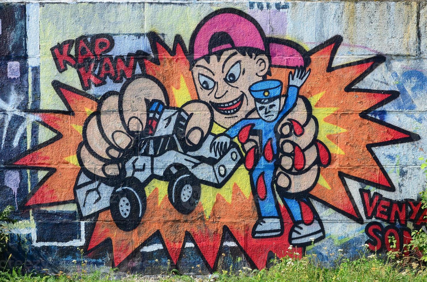 Fragment of graffiti drawings. The old wall decorated with paint stains in the style of street art culture. Child breaks police toys photo