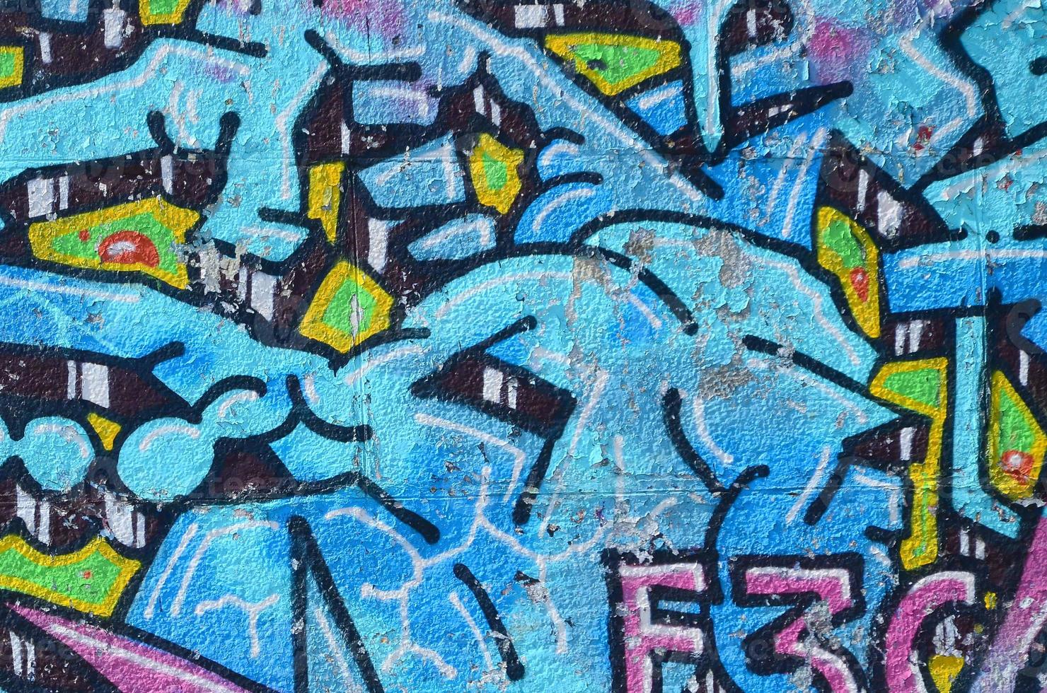 Fragment of graffiti drawings. The old wall decorated with paint stains in the style of street art culture. Colored background texture in cold tones photo