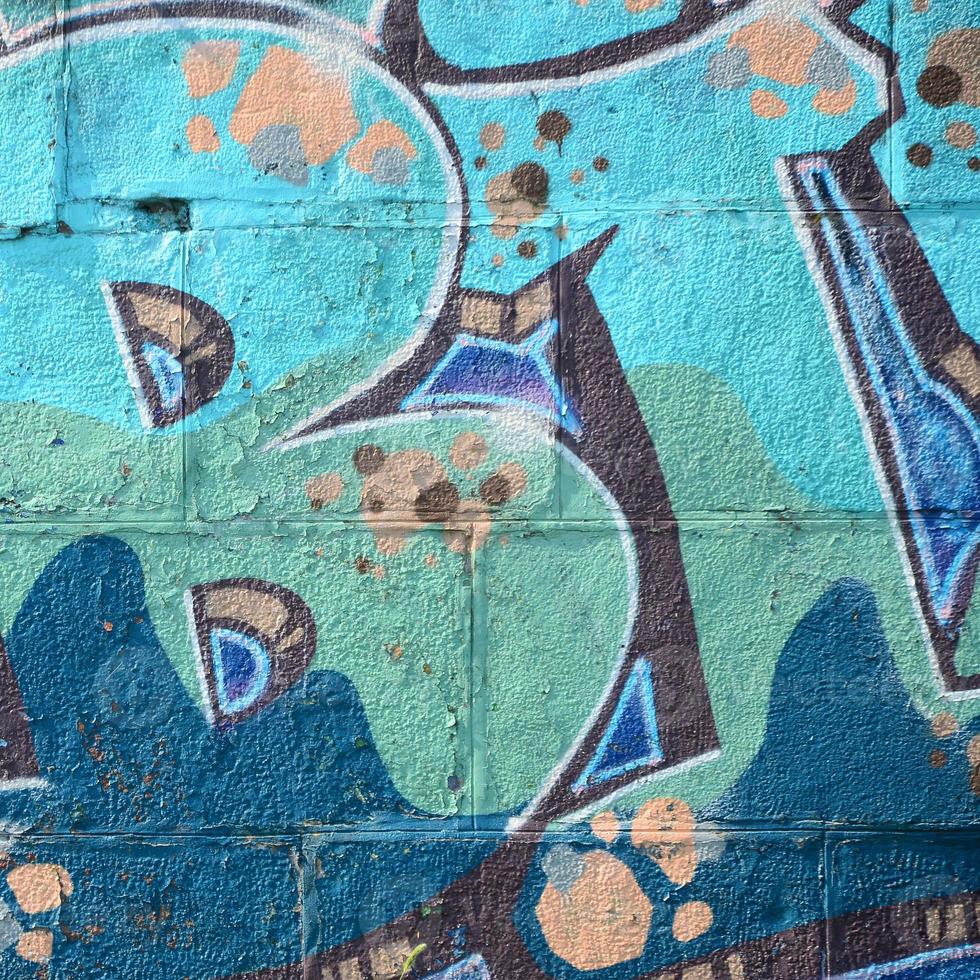 Fragment of graffiti drawings. The old wall decorated with paint stains in the style of street art culture. Colored background texture in cold tones photo