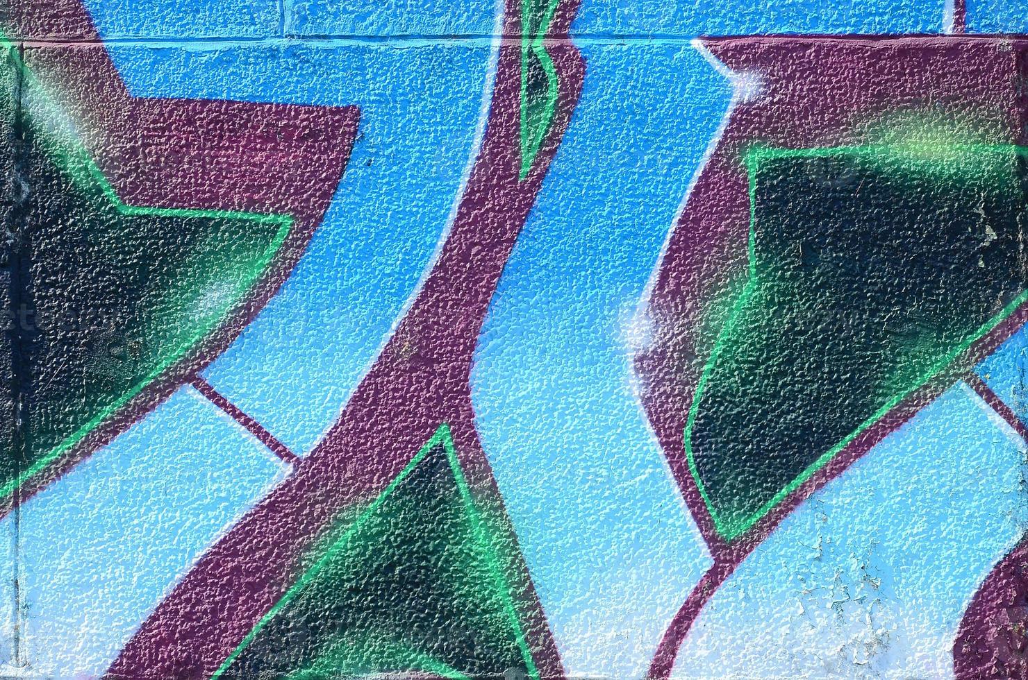 Fragment of graffiti drawings. The old wall decorated with paint stains in the style of street art culture. Colored background texture in cold tones photo