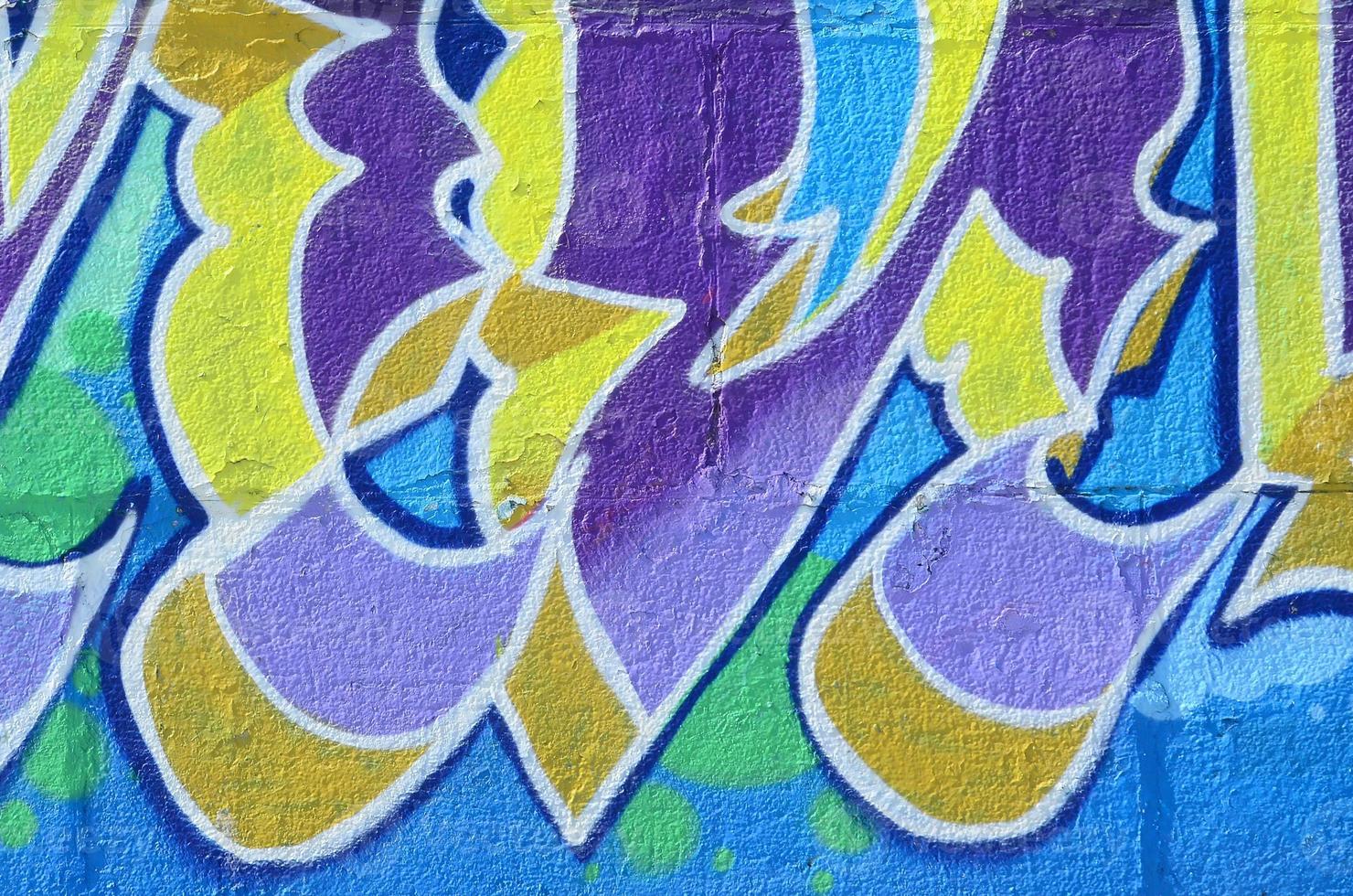 Fragment of graffiti drawings. The old wall decorated with paint stains in the style of street art culture. Colored background texture in cold tones photo