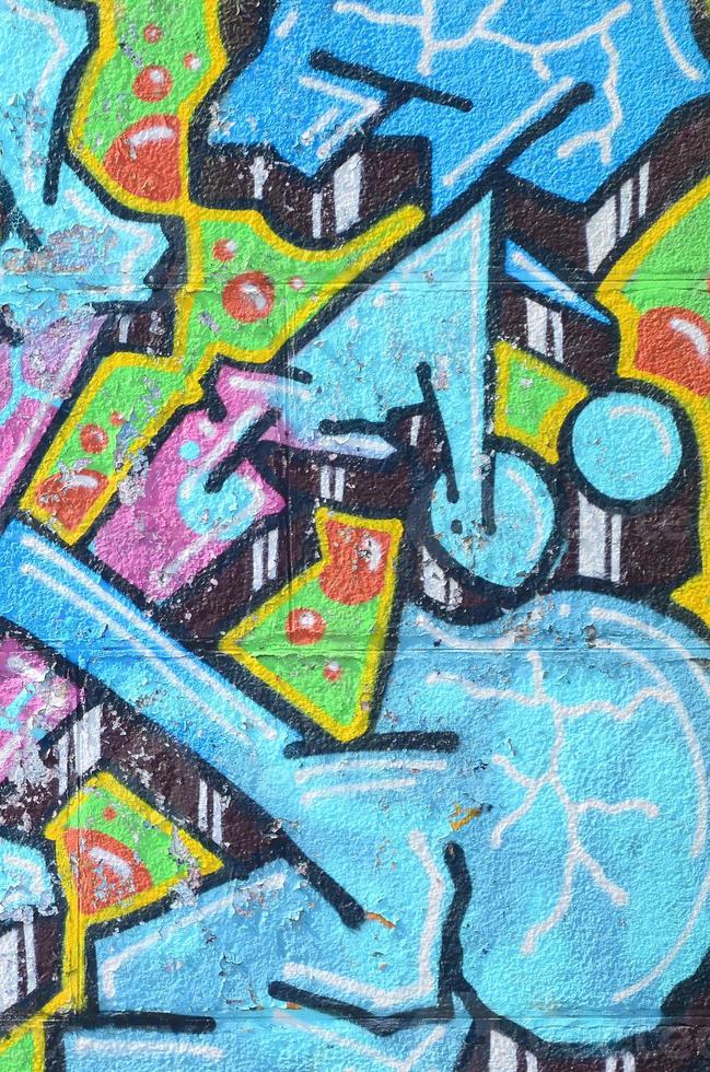 fragmento de dibujos de graffiti. la antigua muralla decorada con manchas de pintura al estilo de la cultura del arte callejero. textura de fondo coloreada en tonos fríos foto