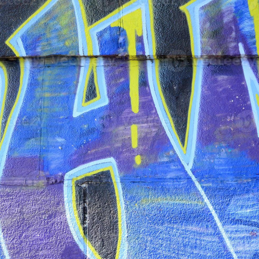 Fragment of graffiti drawings. The old wall decorated with paint stains in the style of street art culture. Colored background texture in cold tones photo