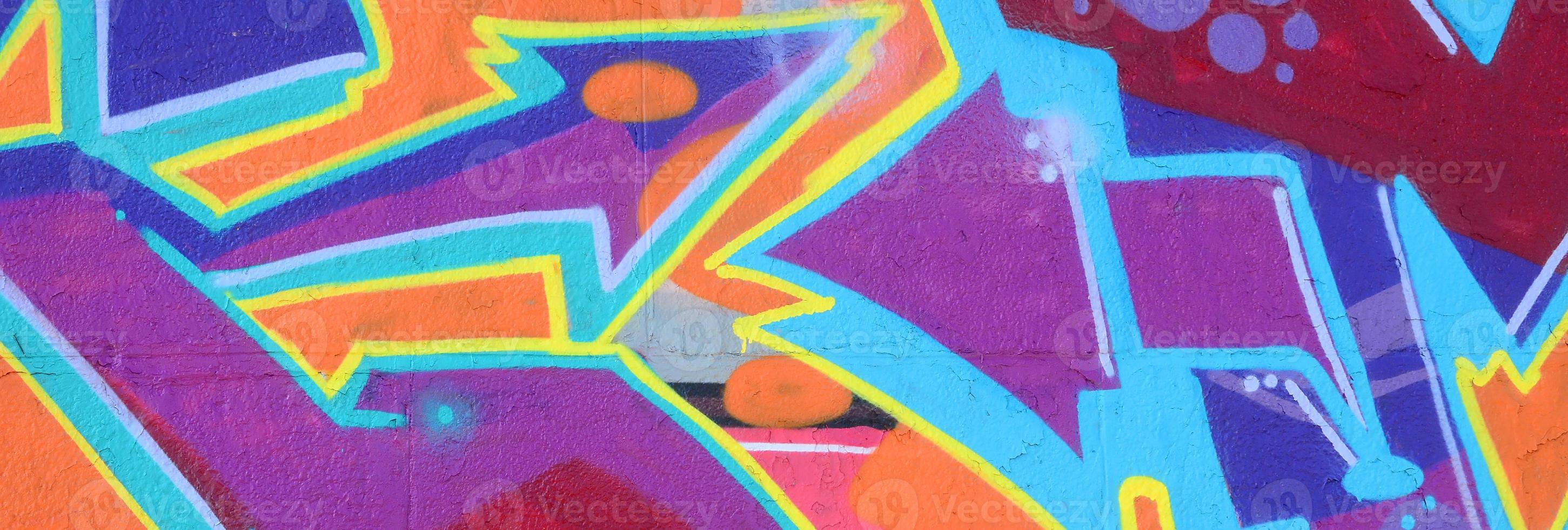 Fragment of graffiti drawings. The old wall decorated with paint stains in the style of street art culture. Colored background texture in purple tones photo
