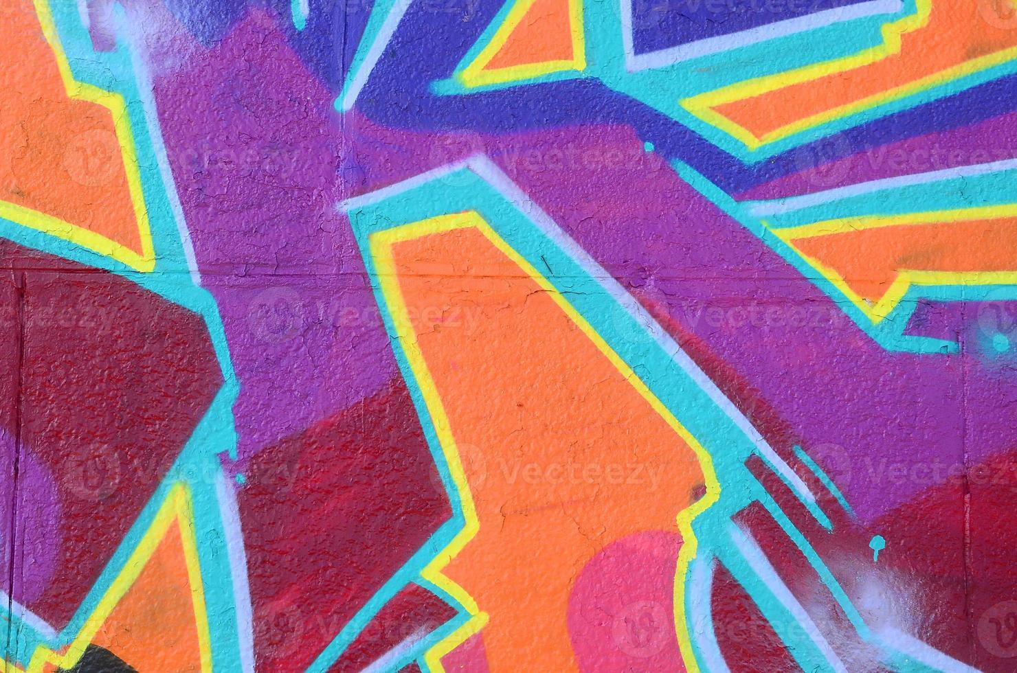 Fragment of graffiti drawings. The old wall decorated with paint stains in the style of street art culture. Colored background texture in purple tones photo
