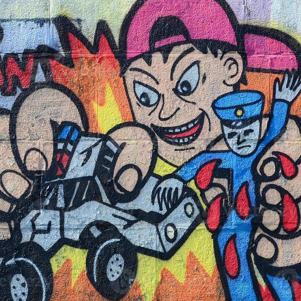 Fragment of graffiti drawings. The old wall decorated with paint stains in the style of street art culture. Child breaks police toys photo